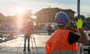 Surveyors using equipment on a residential site showing why a mortgage survey is not enough at closing