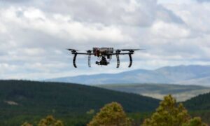 Drone over forested landscape - ALTA SURVEY Maine Drone performing a UAV survey above a dense forest landscape