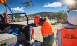 Survey crew operating drone at job site - ALTA SURVEY Maine Field crew using drone land surveying to capture site data for mapping and project planning
