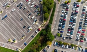 Aerial view of a commercial site with parking areas, access drives, pedestrian crossings, and landscaped areas