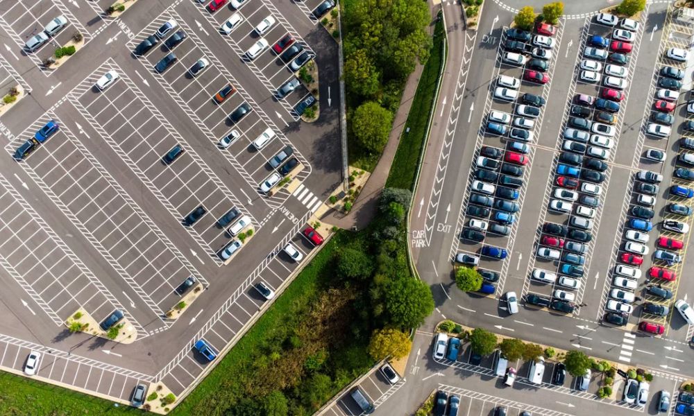 Aerial view of a commercial site with parking areas, access drives, pedestrian crossings, and landscaped areas